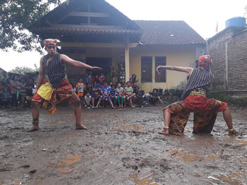 Group of people in front of traditional building