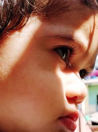 Sunlight falling on thoughtful baby girl