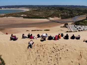 People at beach against sky