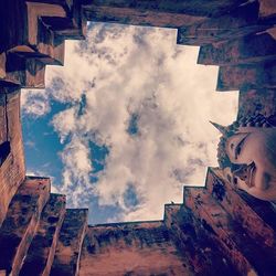 Low angle view of building against cloudy sky