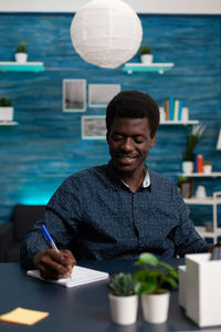 Portrait of young man sitting at table