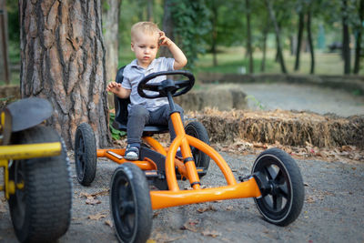 Boy riding motorcycle on land