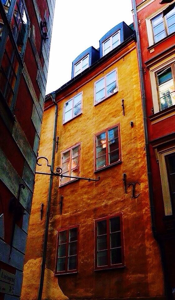 window, architecture, building exterior, built structure, low angle view, residential building, city, building, day, outdoors, city life, repetition, sky, no people, tall, architectural feature, exterior, old town