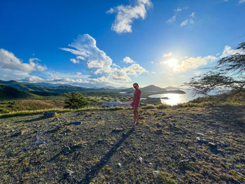 Rear view of man walking on field against sky on the margarita island in venezuela 