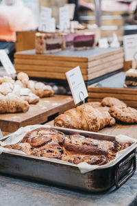 Variety of artisan cakes and pasties on sale at a street market, selective focus.