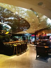 Empty chairs and tables in restaurant