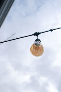 Low angle view of light bulb against sky