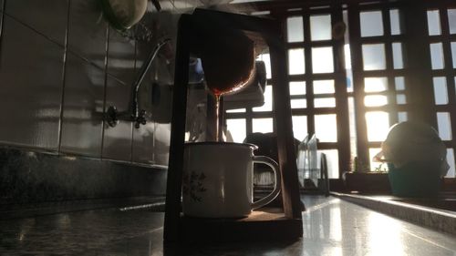 Close-up of drink on table by window