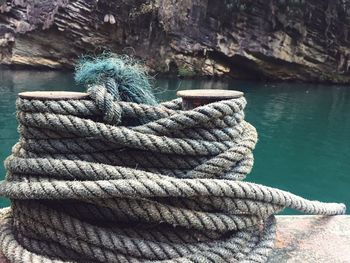 High angle view of rope tied to boat moored in sea