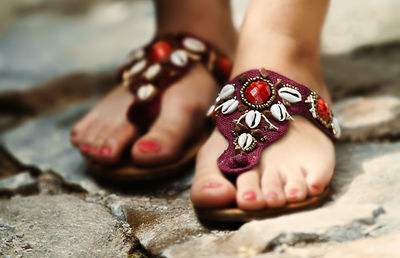 Low section of woman in fashionable flip-flops