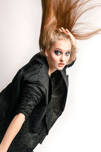 Portrait of beautiful woman against white background