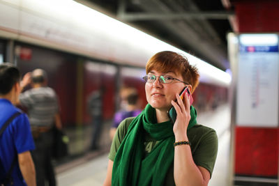 Portrait of woman standing on mobile phone