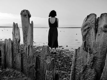 Rear view of man standing on rocks