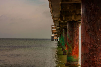 View of built structure by sea