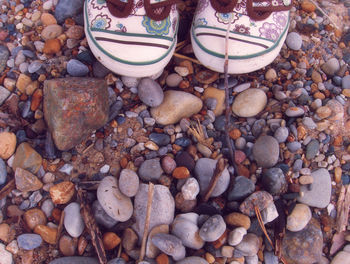 Low section of shoes on pebbles