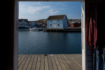 Buildings by sea against sky