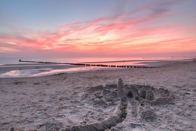 Scenic view of beach against sky during sunset