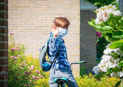 A school boy back to school with mask after pandemic coronavirus