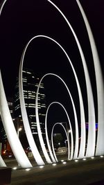 Illuminated ferris wheel against sky at night