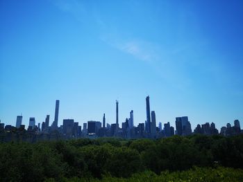 View of modern buildings against blue sky