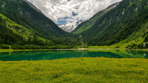 Scenic view of lake and mountains against sky