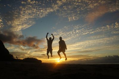 Silhouette of people at sunset