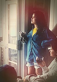 Young man sitting by window at home