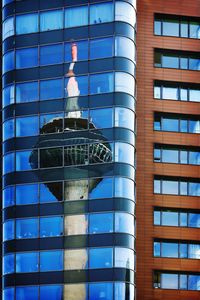 Low angle view of modern glass building in city