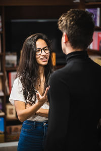 Rear view of a smiling young woman