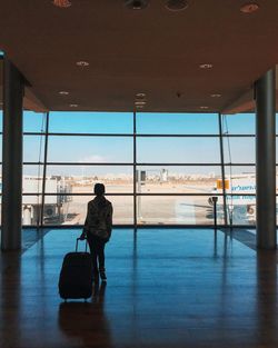 Rear view of a man and woman at airport