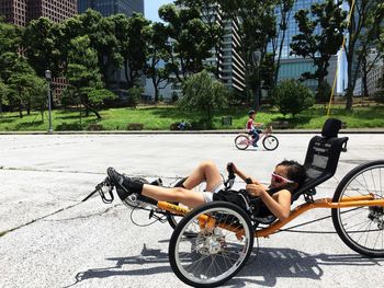 Man riding bicycle on road in city