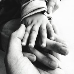 Close-up of hand holding baby