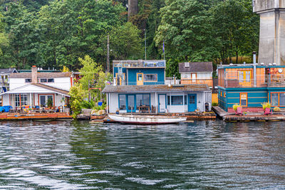 Boats in river by buildings in city