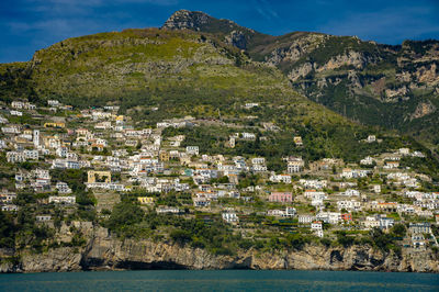 High angle view of townscape by sea against sky