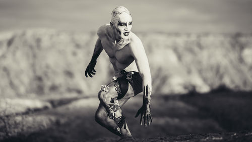 Man with spooky make-up standing on ground