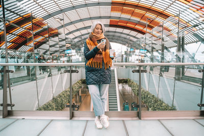 Full length of young woman standing in city