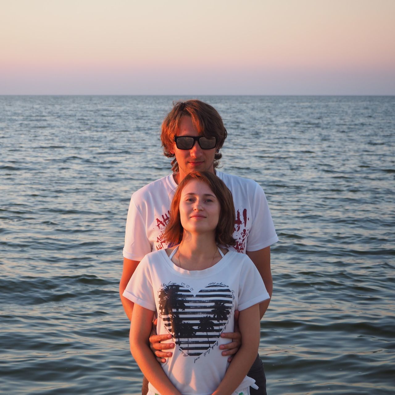 water, two people, sea, sky, leisure activity, real people, glasses, lifestyles, front view, women, horizon, sunglasses, beauty in nature, scenics - nature, portrait, horizon over water, togetherness, bonding, looking at camera, fashion, outdoors