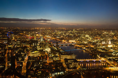 Aerial view of illuminated city buildings at night