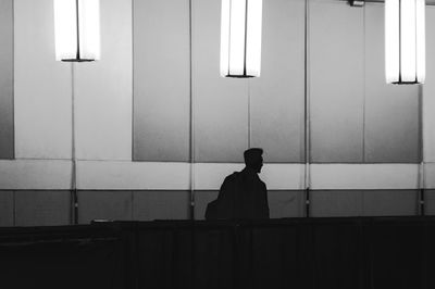 Man looking through window in building