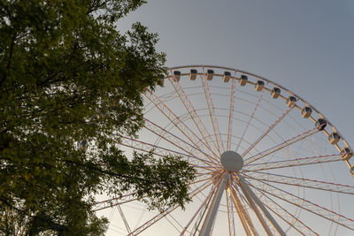 Low angle view of ferris wheel against sky