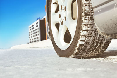 Close-up of snow on land against sky