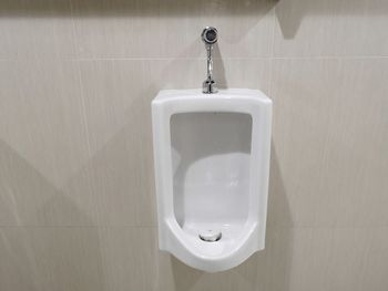 Close-up of urinal in bathroom