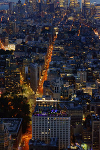 Aerial view of city lit up at night