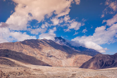 Scenic view of mountains against cloudy sky