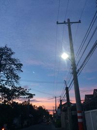 Low angle view of illuminated cables against sky