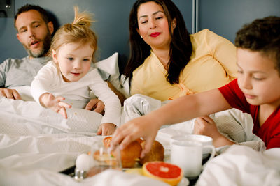 Family having breakfast in bed