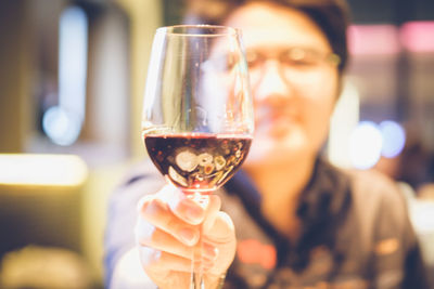 Woman holding wineglass at restaurant