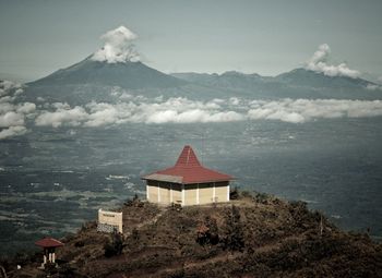 Built structure on snowcapped mountain against sky