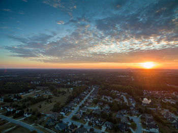 Aerial view of town against sky during sunset