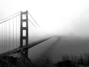 View of suspension bridge in foggy weather